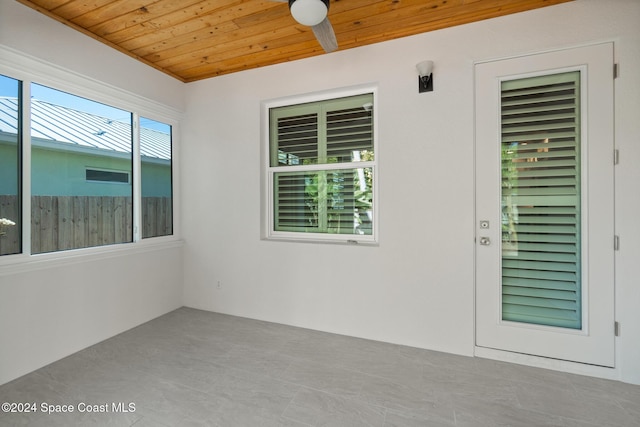 unfurnished sunroom featuring ceiling fan and wooden ceiling