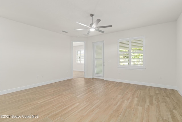 empty room featuring ceiling fan and light hardwood / wood-style floors