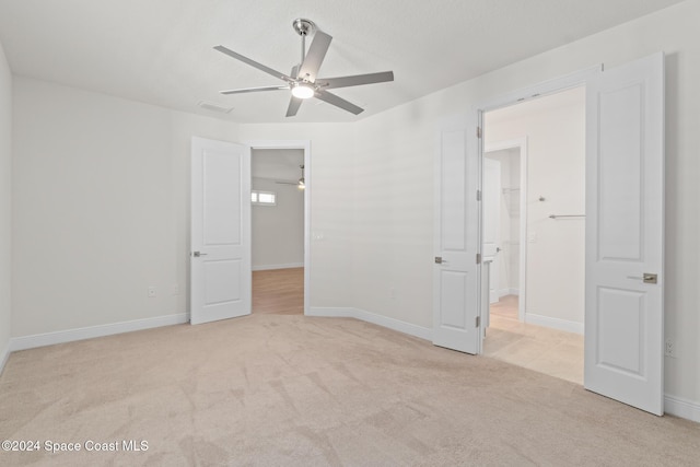 empty room featuring light colored carpet and ceiling fan