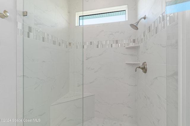 bathroom with a tile shower