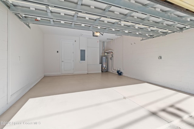 garage featuring gas water heater, a garage door opener, and electric panel