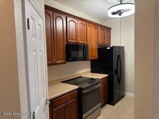 kitchen featuring light tile patterned flooring and black appliances