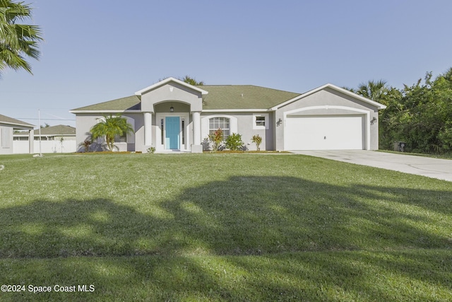 view of front of house featuring a garage and a front yard