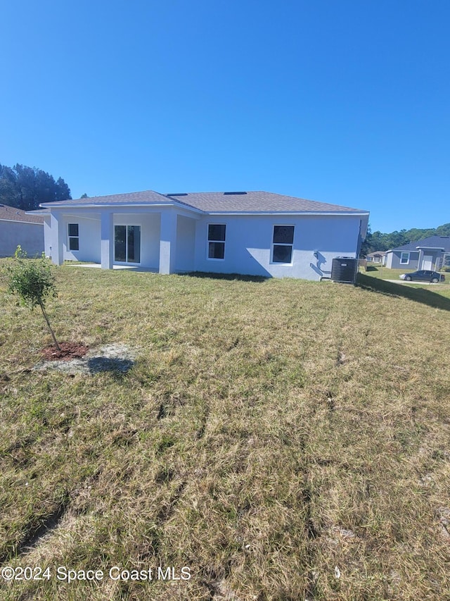 rear view of house with a yard