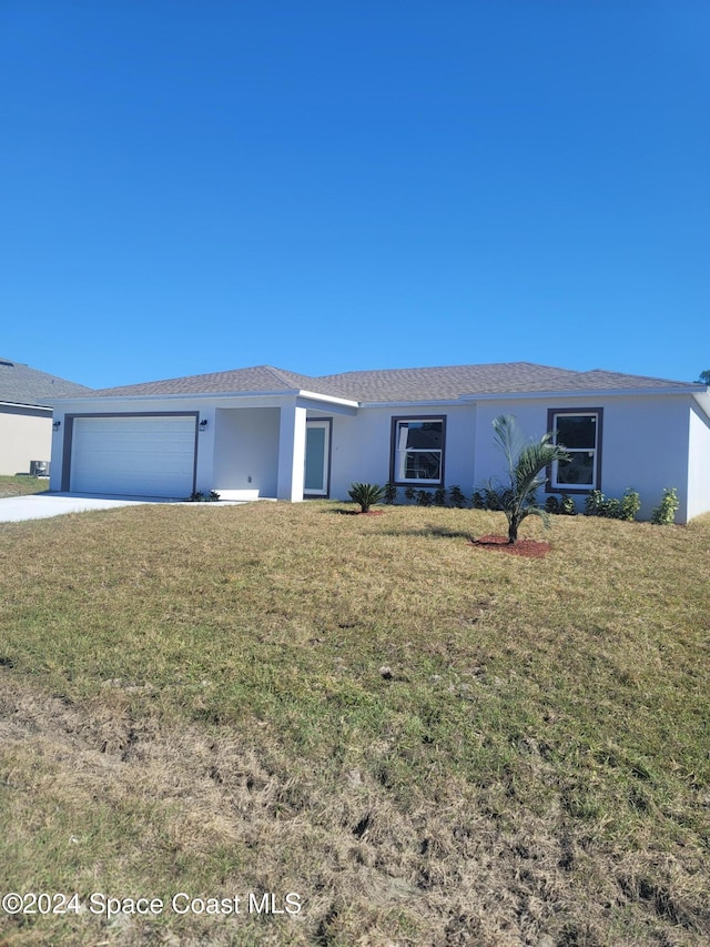 single story home featuring a front yard and a garage