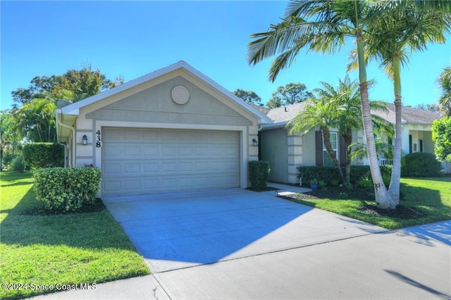 single story home featuring a front lawn and a garage