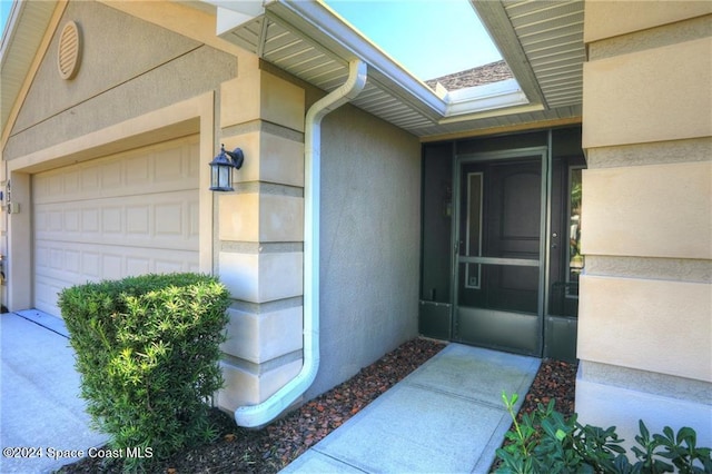 view of exterior entry featuring a garage