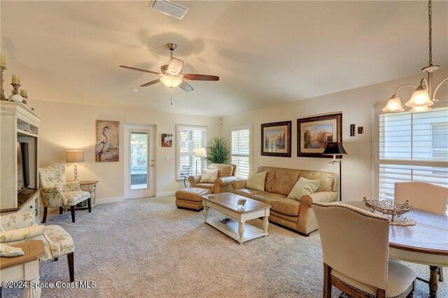 438 Briarcliff Cir, Sebastian, FL 32958 - living room featuring light carpet and ceiling fan with notable chandelier