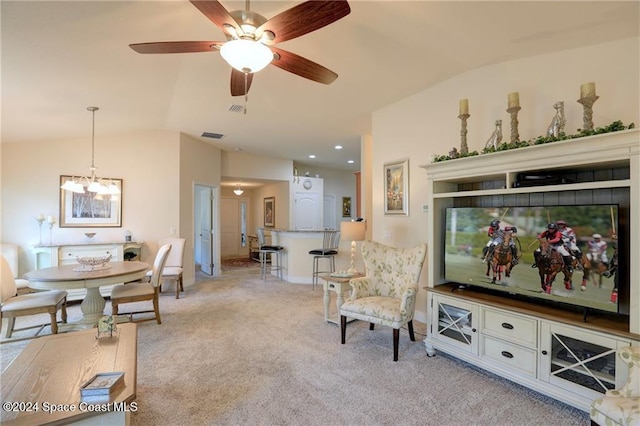 living room with ceiling fan with notable chandelier, lofted ceiling, and light carpet