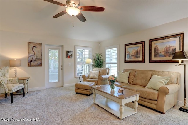 carpeted living room with ceiling fan