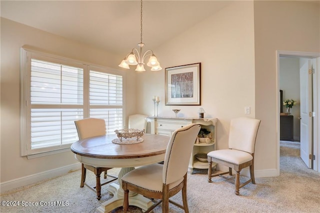 carpeted dining room featuring a chandelier and lofted ceiling