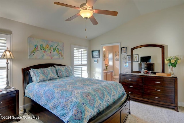 carpeted bedroom with ensuite bath, ceiling fan, and lofted ceiling