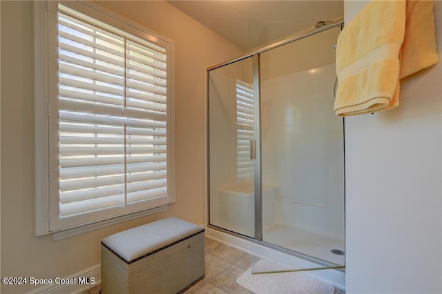 bathroom featuring a shower with shower door