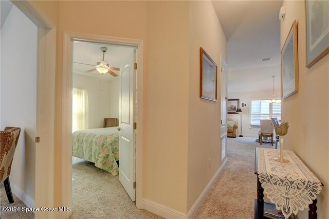 hallway featuring light colored carpet