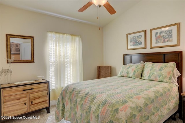 carpeted bedroom with ceiling fan and lofted ceiling