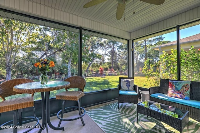 sunroom featuring ceiling fan