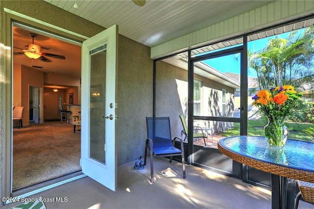 sunroom featuring french doors and ceiling fan