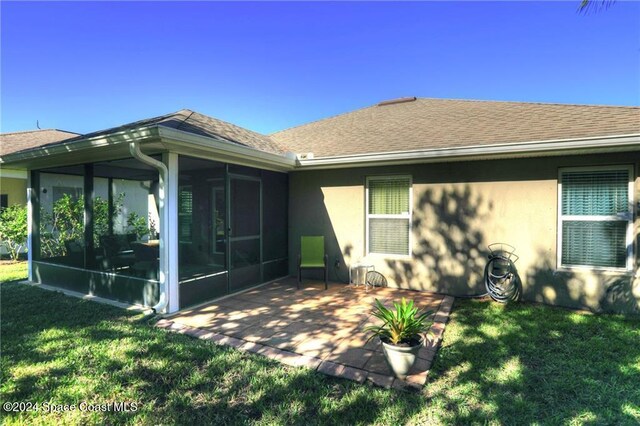 438 Briarcliff Cir, Sebastian, FL 32958 - rear view of house with a lawn, a patio area, and a sunroom