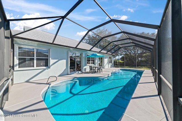 view of pool featuring a lanai and a patio area