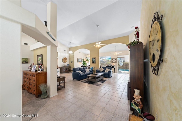 living room featuring ceiling fan, light tile patterned floors, and high vaulted ceiling