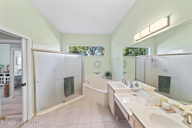 bathroom with tile patterned flooring, vanity, and shower with separate bathtub