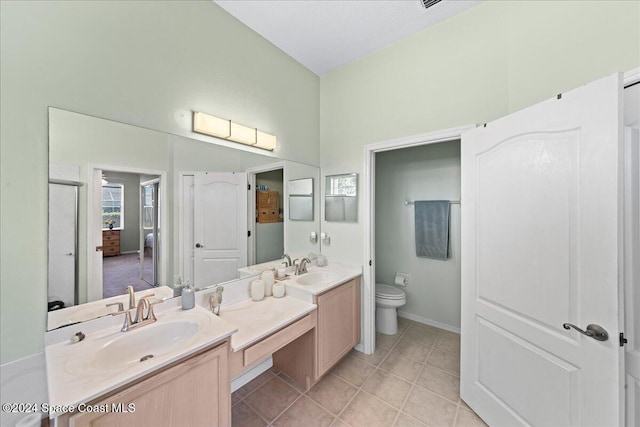 bathroom featuring tile patterned floors, vanity, and toilet