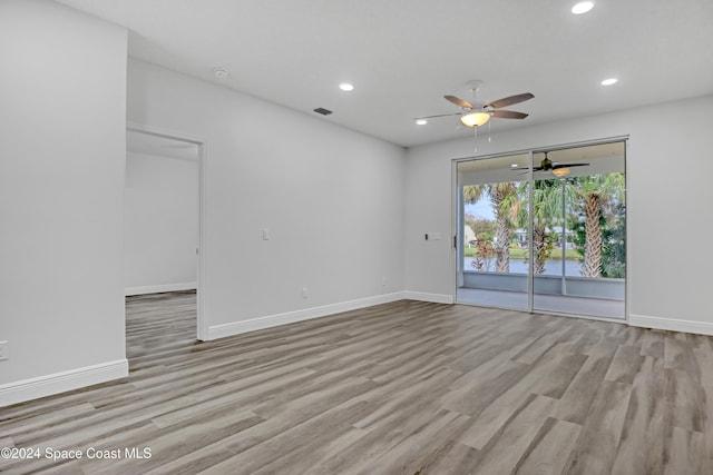 empty room featuring light hardwood / wood-style flooring and ceiling fan