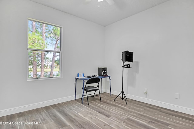 home office featuring ceiling fan, a textured ceiling, and hardwood / wood-style flooring