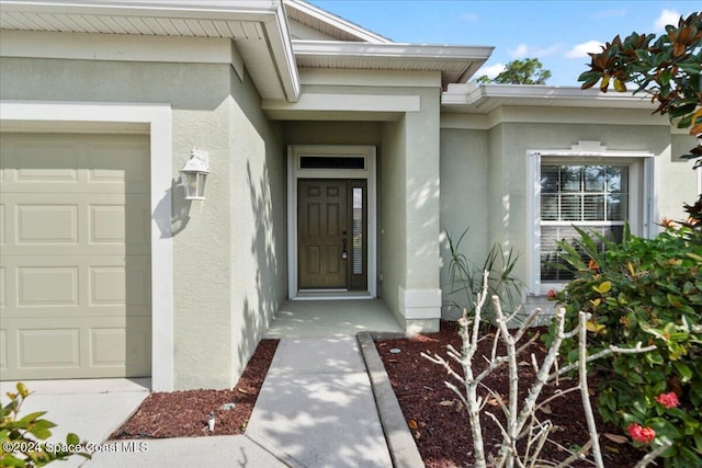 doorway to property featuring a garage