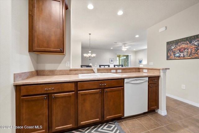 kitchen with kitchen peninsula, ceiling fan with notable chandelier, white dishwasher, sink, and pendant lighting