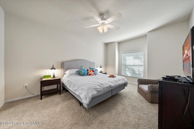 carpeted bedroom with a textured ceiling and ceiling fan