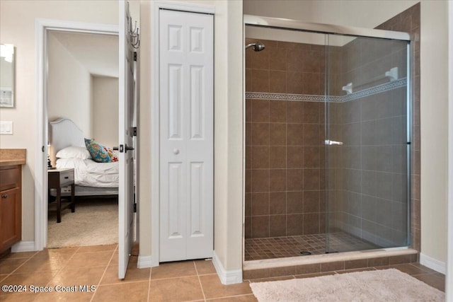 bathroom with tile patterned flooring, vanity, and walk in shower