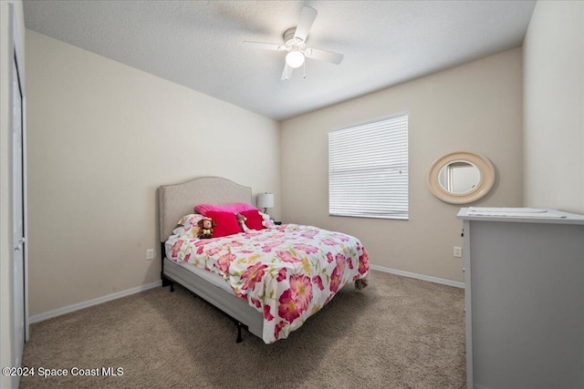 bedroom featuring ceiling fan and light carpet