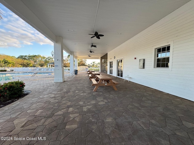 view of patio with a fenced in pool, ceiling fan, and french doors