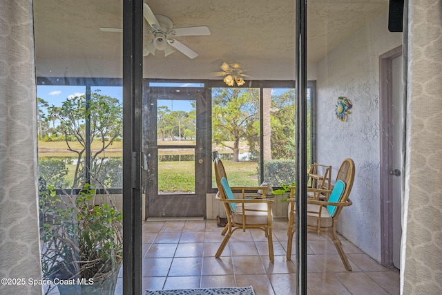 sunroom featuring ceiling fan