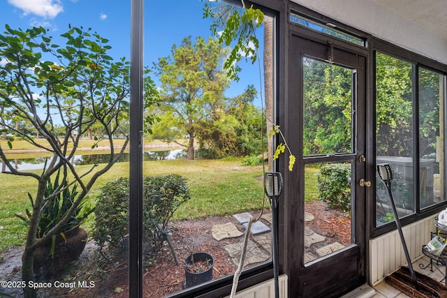 doorway to outside featuring a water view