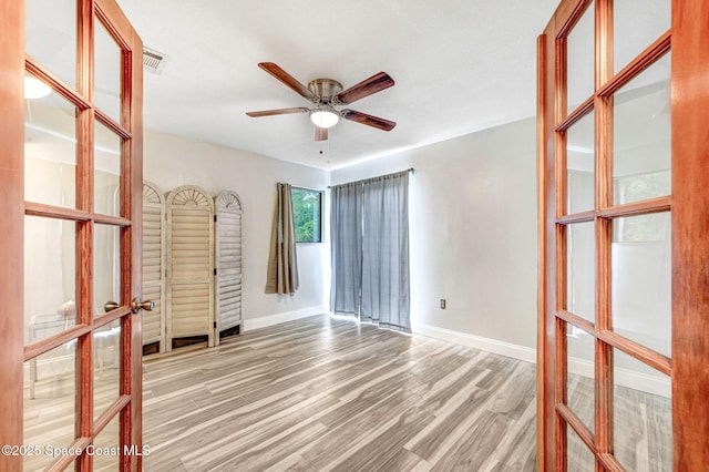 unfurnished room featuring ceiling fan and hardwood / wood-style floors