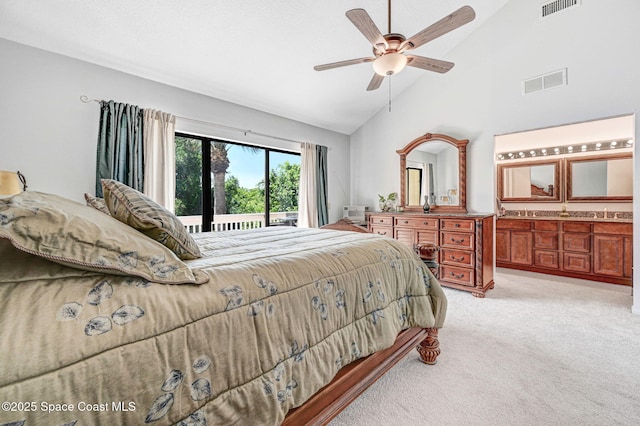 carpeted bedroom with connected bathroom, high vaulted ceiling, and ceiling fan