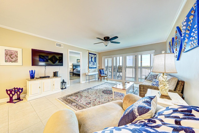 living room featuring light tile patterned floors, ceiling fan, and crown molding