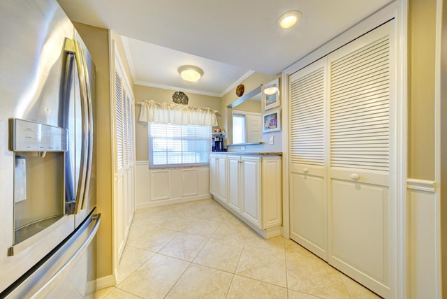 kitchen with light stone countertops, stainless steel fridge with ice dispenser, light tile patterned floors, and ornamental molding