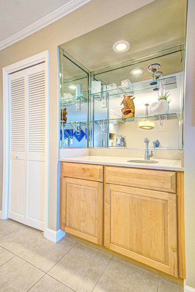 bar with light tile patterned floors, crown molding, and sink