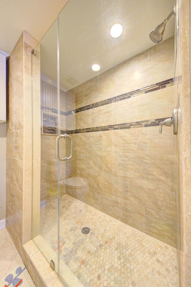 bathroom with tile patterned floors and a shower with door