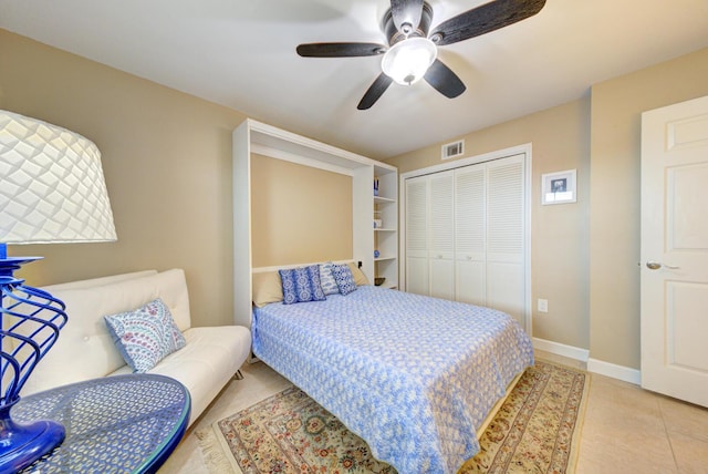 bedroom with ceiling fan, a closet, and light tile patterned floors