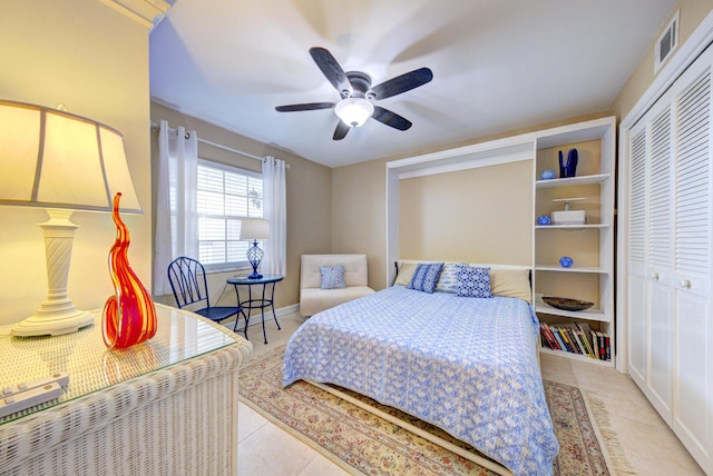 tiled bedroom featuring a closet and ceiling fan