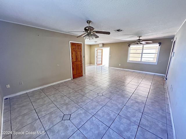 tiled empty room with a textured ceiling and ceiling fan