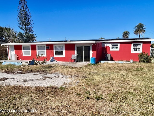 back of house with a lawn