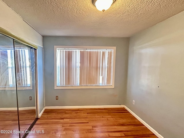 interior space featuring hardwood / wood-style floors and a textured ceiling