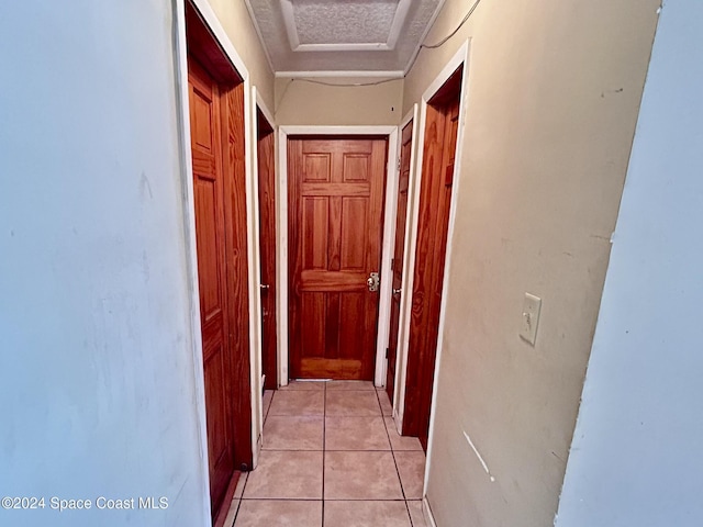 corridor with light tile patterned flooring