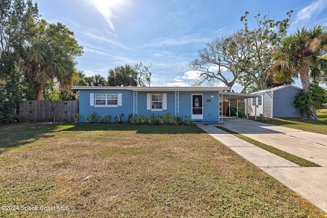 ranch-style home featuring a carport and a front yard