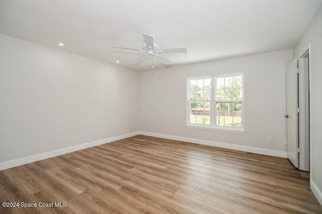 spare room featuring ceiling fan and light hardwood / wood-style flooring